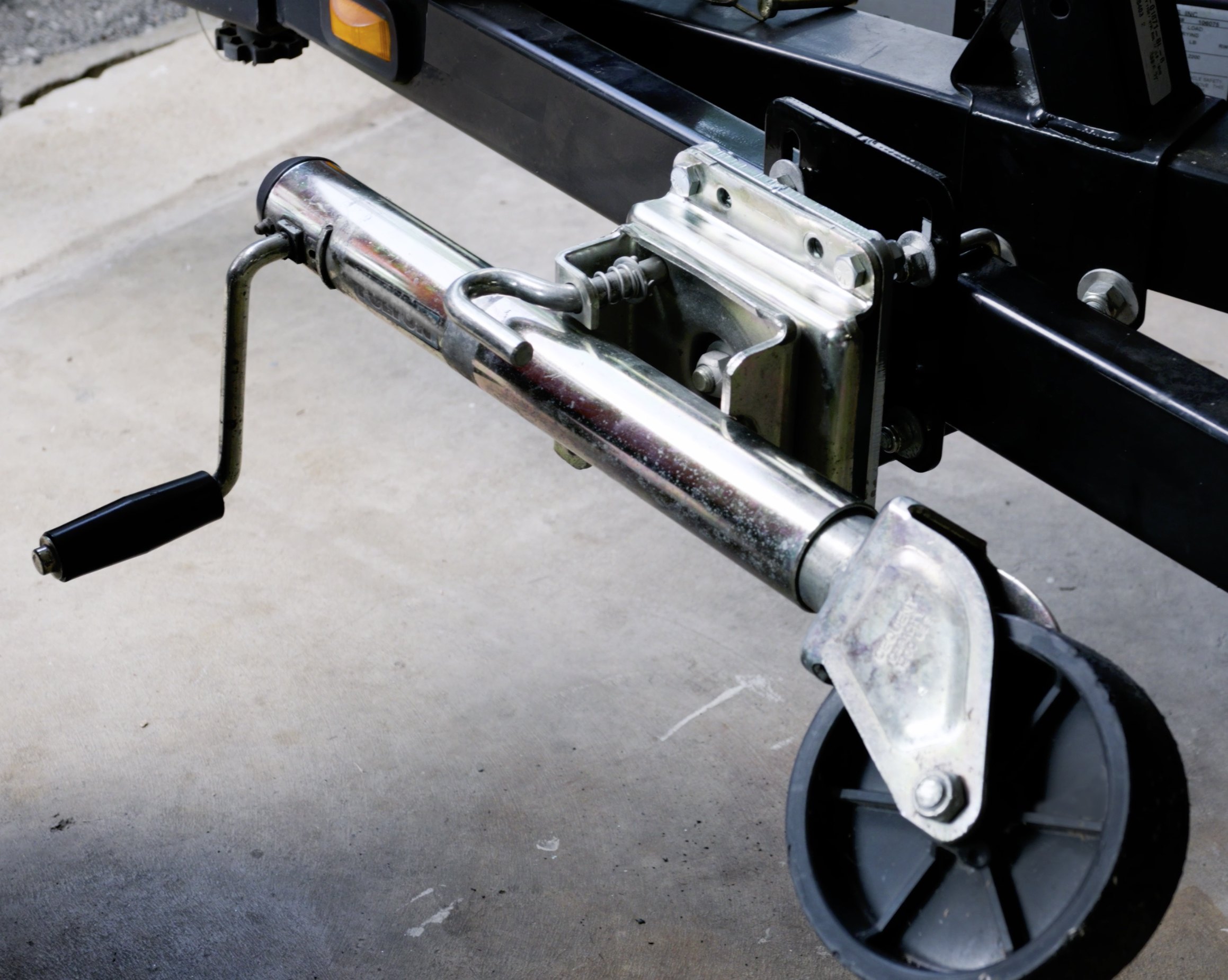 A trailer tongue jack with the Jack Bracket mounted to the trailer frame